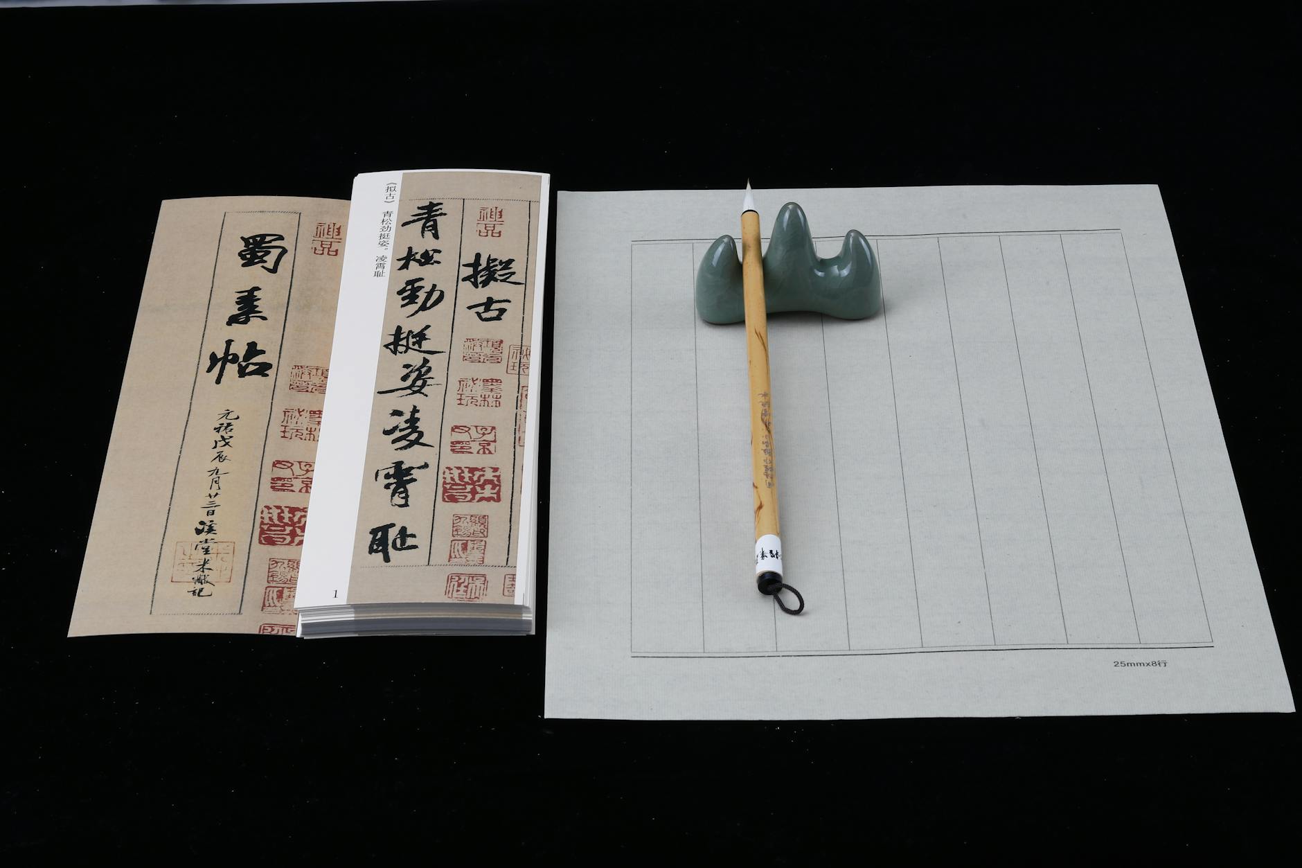 Elegant setup of traditional Chinese calligraphy tools featuring brushes, paper, and a holder.